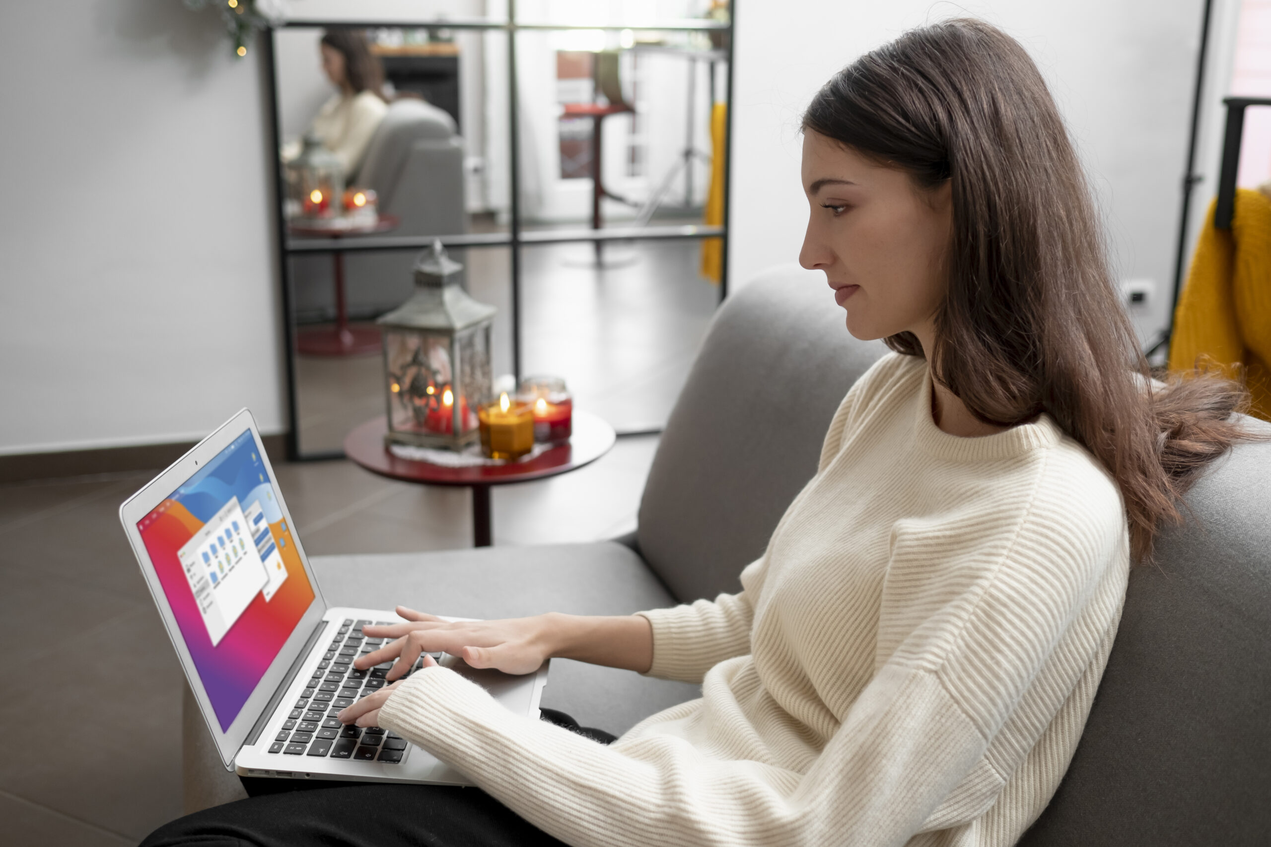 Woman working on a laptop, researching guest post backlinks to improve SEO strategy.